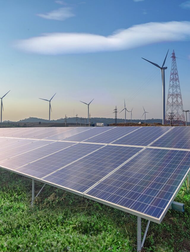 renewable-energy-solar-panels-wind-turbines-green-grass-blue-sky