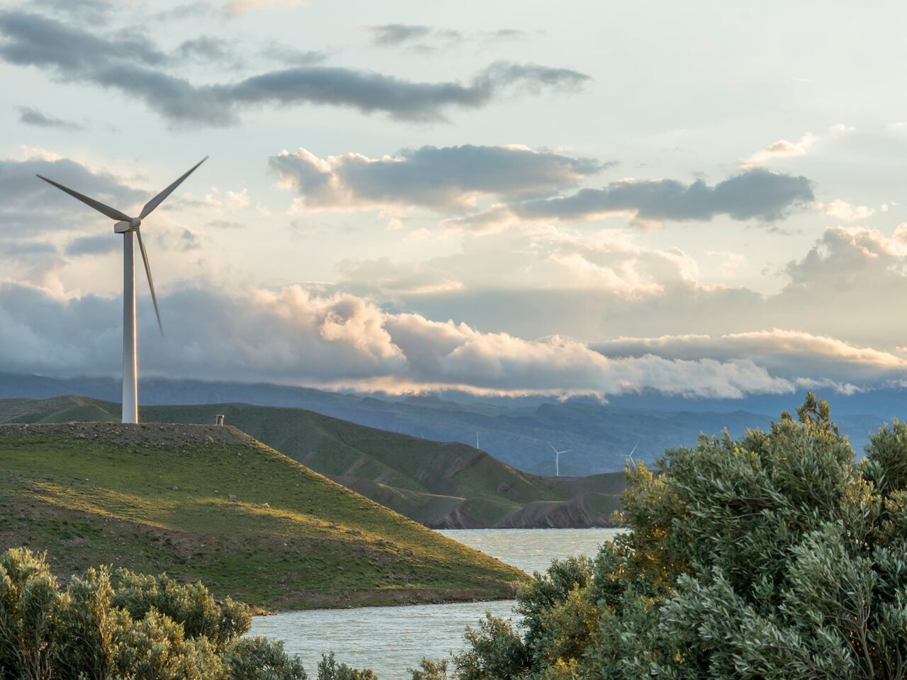 wind-power-turbine-hill-front-cloudy-sky